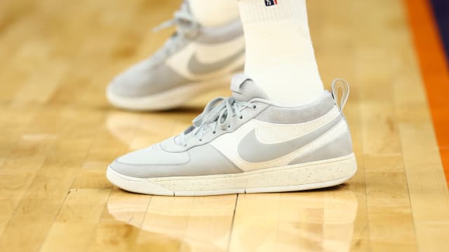 Phoenix Suns guard Devin Booker's white and grey Nike sneakers.