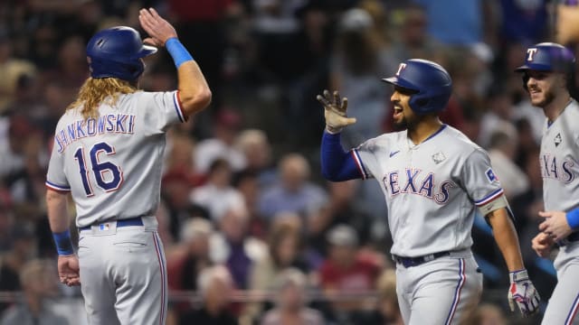 Texas Rangers right fielder Travis Jankowski (16) congratulates second baseman Marcus Semien (2) after a three-run home run during the third inning against the Arizona Diamondbacks in Game 4 of the 2023 World Series at Chase Field in Phoenix, AZ. The DBacks lost to the Rangers 11-7, putting the Ranger at 3-1 in the World Series.  