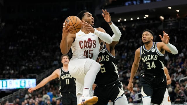 Jan 26, 2024; Milwaukee, Wisconsin, USA; Cleveland Cavaliers guard Donovan Mitchell (45) drives for the basket in front of Milwaukee Bucks guard Malik Beasley (5) during the third quarter at Fiserv Forum. Mandatory Credit: Jeff Hanisch-USA TODAY Sports