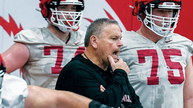 Arkansas coach Sam Pittman looks on as the offensive line works through drills on the second day of spring practices.