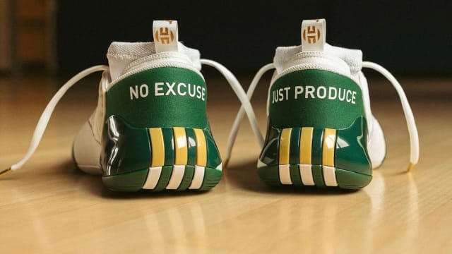 Rear view of James Harden's green and gold adidas shoes.