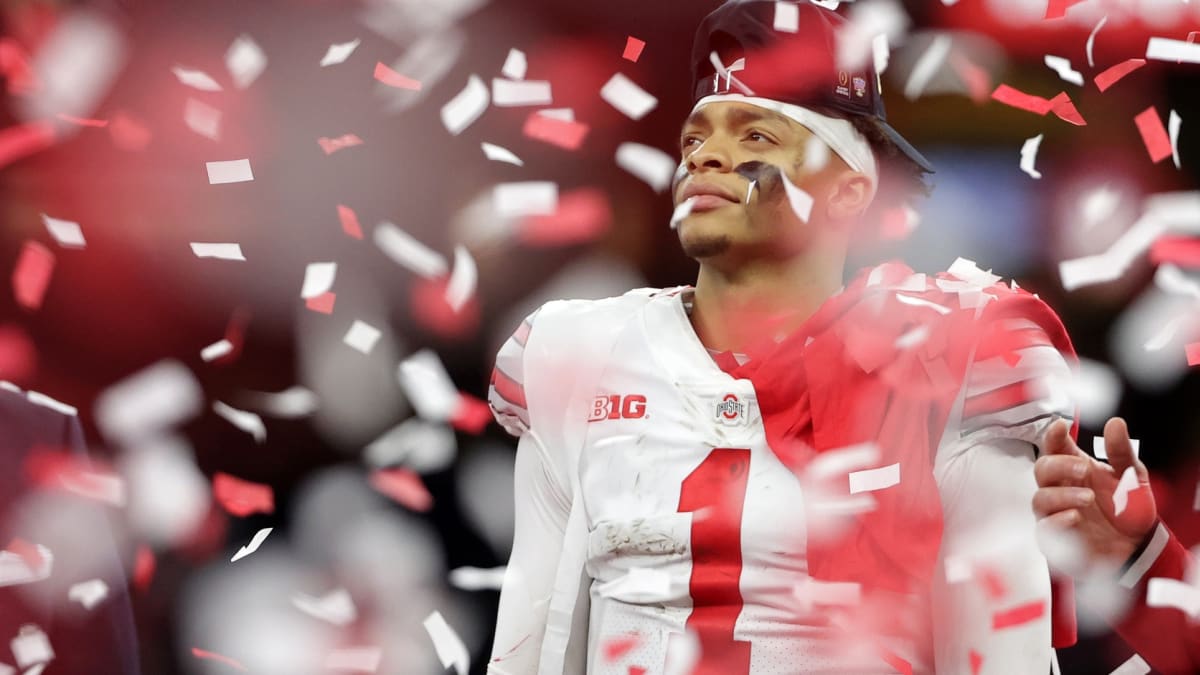 Download Ohio State Quarterback Justin Fields Throwing a Pass Against  Michigan Wallpaper
