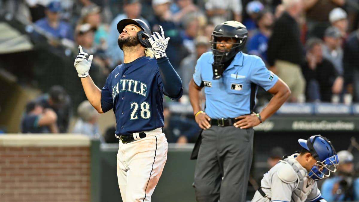 Seattle Mariners' Eugenio Suarez, right, is congratulated by Sam