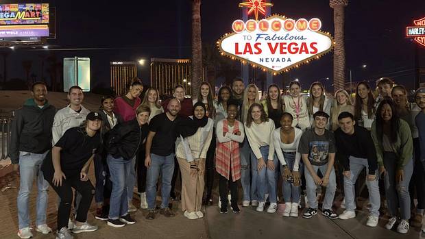 The Indiana women's basketball program stands in front of the Las Vegas sign.