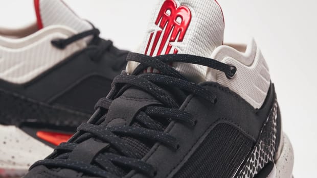 Detailed look white, red, and black New Balance shoes.