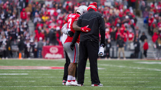 Miyan Williams is helped off the field after hurting his right leg.