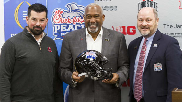 Ryan Day, Gene Smith and Peach Bowl CEO Gary Stokan pose for a picture at the Woody Hayes Athletic Center after the Buckeyes officially accepted the invitation to play in the CFP in Atlanta.