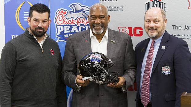 Ryan Day, Gene Smith and Peach Bowl CEO Gary Stokan pose for a picture at the Woody Hayes Athletic Center after the Buckeyes officially accepted the invitation to play in the CFP in Atlanta.