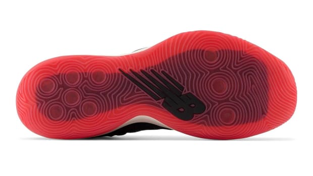 Red outsole of New Balance shoe.