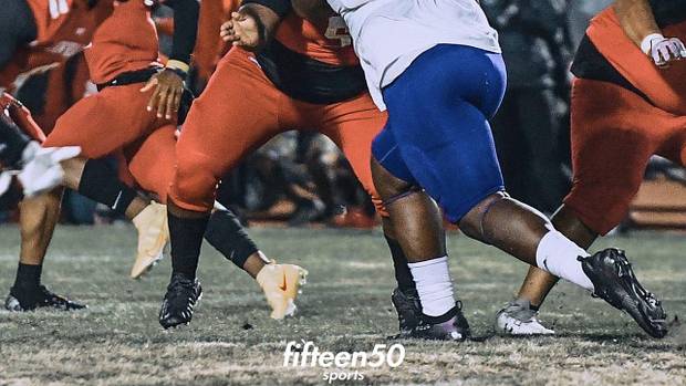 Wisconsin defensive line target Ashton Sanders doing a pass-rush move in a game during his junior year.