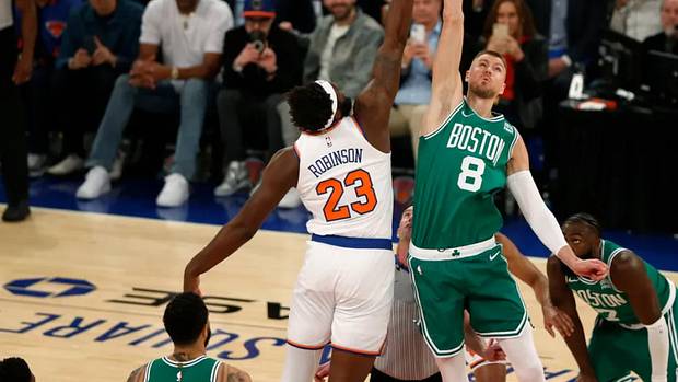 Kristaps Porzingis (8) makes Wednesday's opening tip-off against Mitchell Robinson