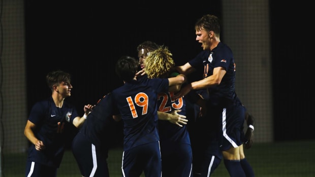 The Virginia Cavaliers men's soccer team celebrates after scoring a goal against the Pittsburgh Panthers.