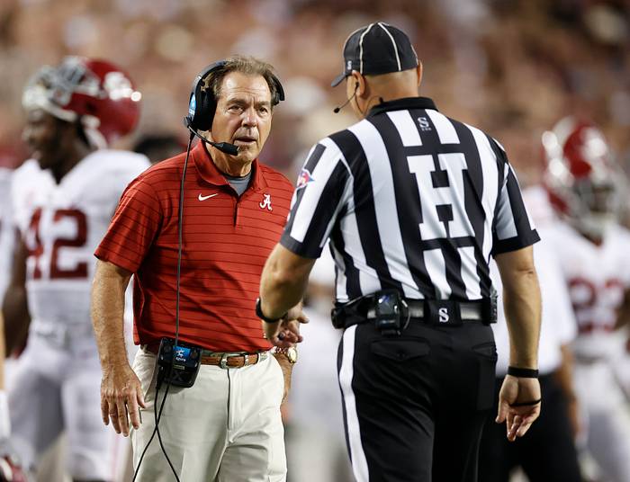 Nick Saban talks to an official