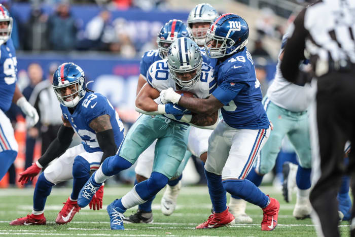 Dec 19, 2021; East Rutherford, New Jersey, USA; Dallas Cowboys running back Tony Pollard (20) is tackled by New York Giants inside linebacker Tae Crowder (48) during the second half at MetLife Stadium.