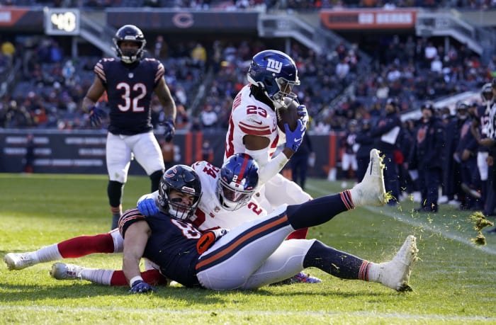 Jan 2, 2022; Chicago, Illinois, USA; New York Giants safety Logan Ryan (23) makes an interception on Chicago Bears tight end Cole Kmet (85) but was called back for pass interfence during the second half at Soldier Field.