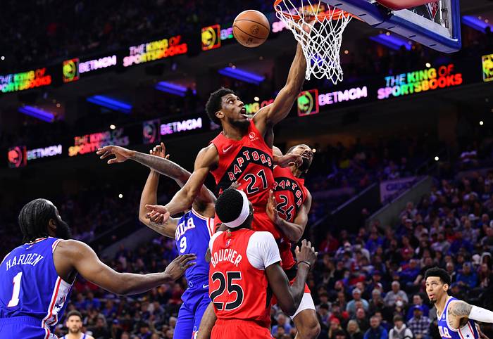 Toronto Raptors forward Thaddeus Young (21) grabs the rim after missing a shot over Philadelphia 76ers center DeAndre Jordan (9) in the second quarter at Wells Fargo Center
