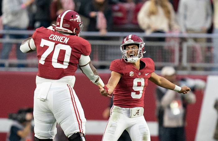 Alabama Crimson Tide quarterback Bryce Young (9) celebrates with Alabama Crimson Tide offensive lineman Javion Cohen (70) after a touchdown against the Auburn Tigers during the first half at Bryant-Denny Stadium.