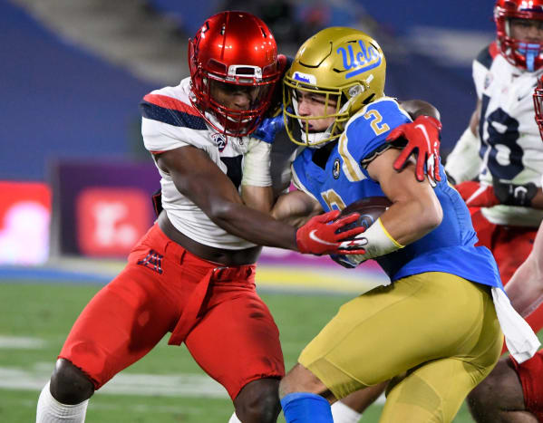 Arizona Wildcats defensive back Christian Roland-Wallace (4) tackles UCLA Bruins wide receiver Kyle Philips (2) during a third quarter running play at the Rose Bowl.