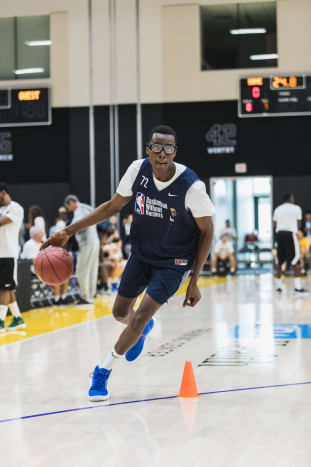 Christian Koloko dribbles around a pylon at the 2018 Basketball Without Borders camp in Los Angeles