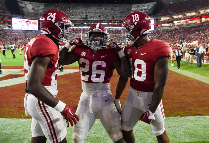 Alabama Crimson Tide running back Jamarion Miller (26) celebrates with wide receiver/running back Emmanuel Henderson Jr. (24) and wide receiver Shazz Preston (18) after scoring a touchdown against the Vanderbilt Commodores at Bryant-Denny Stadium. Alabama won 55-3.