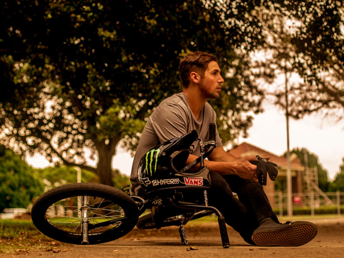 Scotty Cranmer Sitting at a Park on his Bike