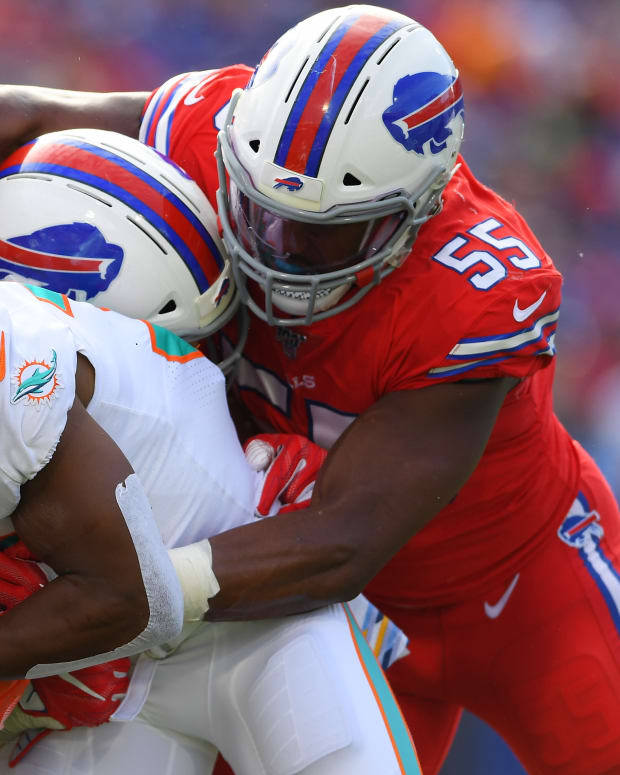 Oct 20, 2019; Orchard Park, NY, USA; Miami Dolphins running back Kenyan Drake (32) runs with the ball as Buffalo Bills defensive end Jerry Hughes (55) defends during the third quarter at New Era Field. Mandatory Credit: Rich Barnes-USA TODAY Sports