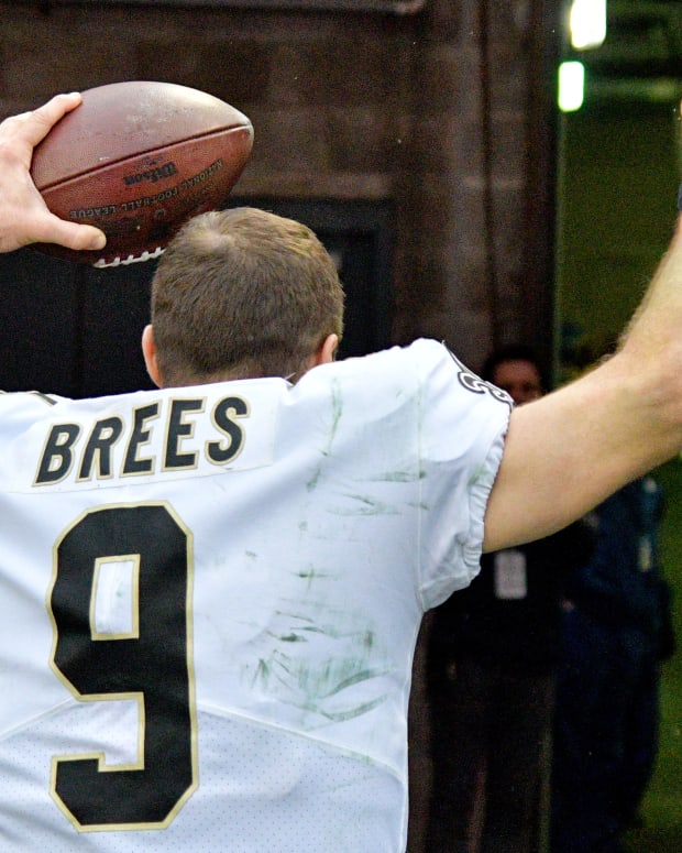 Drew Brees hold the Game Ball for the Saints win over the Titans