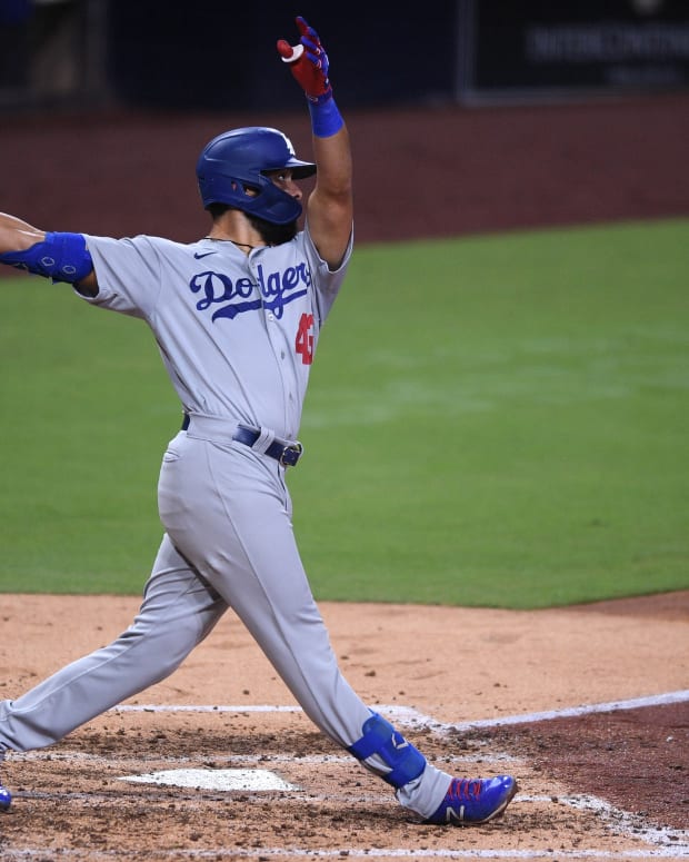 Sep 15, 2020; San Diego, California, USA; Los Angeles Dodgers third baseman Edwin Rios (43) hits a home run against the San Diego Padres during the fifth inning at Petco Park. Mandatory Credit: Orlando Ramirez-USA TODAY Sports