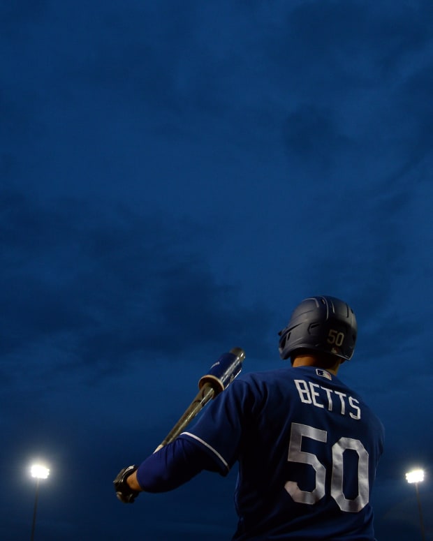 Mar 11, 2020; Phoenix, Arizona, USA; Los Angeles Dodgers right fielder Mookie Betts (50) waits on deck against the Milwaukee Brewers during the first inning of a spring training game at Camelback Ranch. Mandatory Credit: Joe Camporeale-USA TODAY Sports
