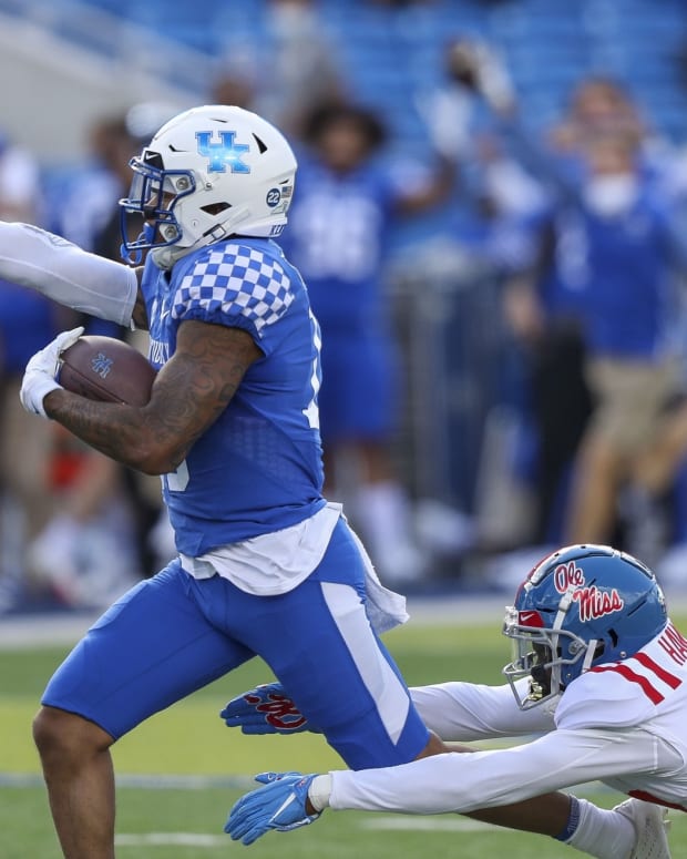 Kentucky Wildcats running back Asim Rose (10) runs with the ball against Mississippi Rebels defensive back Jakorey Hawkins (23) in the first half at Kroger Field. Mandatory Credit: Katie Stratman-USA TODAY Sports