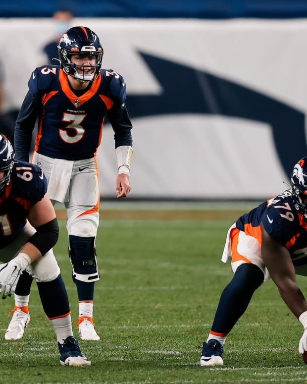 Denver Broncos quarterback Drew Lock (3) behind offensive guard Graham Glasgow (61) and center Lloyd Cushenberry III (79) in the fourth quarter against the Tennessee Titans at Empower Field at Mile High.