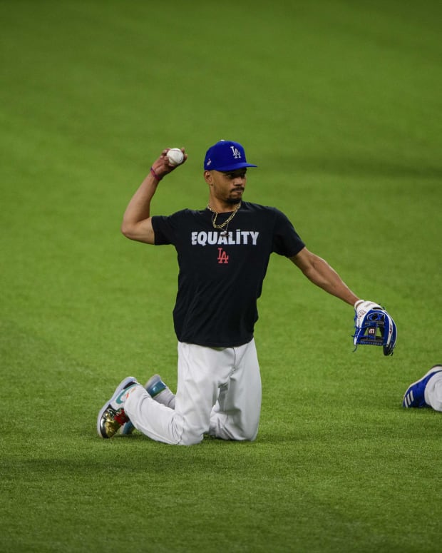 Oct 11, 2020; Arlington, TX, USA; Los Angeles Dodgers right fielder Mookie Betts (50) throws the ball as the Dodgers work out at Globe Life Park. Mandatory Credit: Jerome Miron-USA TODAY Sports