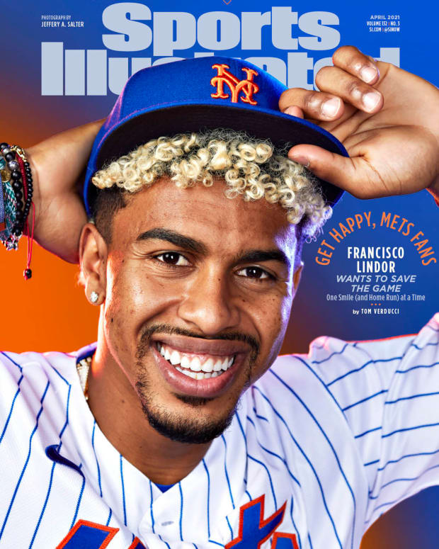 Francisco Lindor poses with his new Mets hat