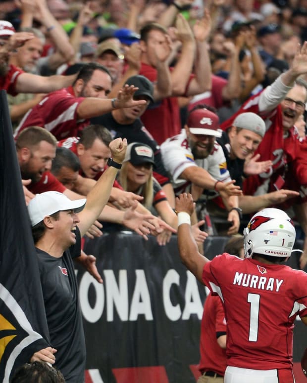 Arizona Cardinals quarterback Kyler Murray (1) celebrates a touchdown with fans during the second half of the game against the Seattle Seahawks at State Farm Stadium.