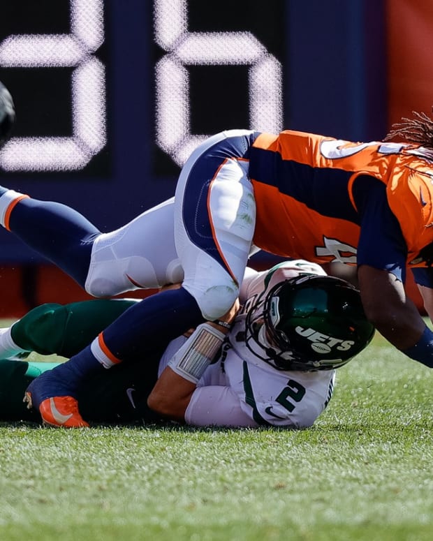 New York Jets quarterback Zach Wilson (2) is sacked by Denver Broncos linebacker Alexander Johnson (45) in the first quarter at Empower Field at Mile High.