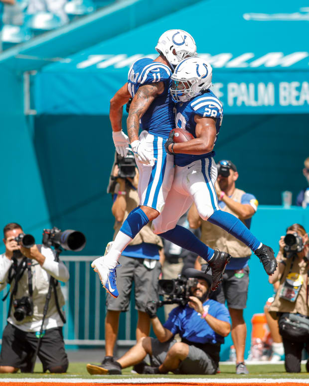 Oct 3, 2021; Miami Gardens, Florida, USA; Indianapolis Colts wide receiver Michael Pittman (11) and running back Jonathan Taylor (28) celebrate after a touchdown by Taylor during the second quarter of the game against the Miami Dolphins at Hard Rock Stadium.
