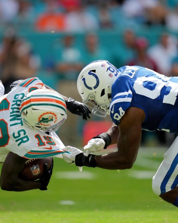 Oct 3, 2021; Miami Gardens, Florida, USA; Indianapolis Colts defensive end Tyquan Lewis (94) tackles Miami Dolphins wide receiver Jakeem Grant (19) during the second half at Hard Rock Stadium. Mandatory Credit: Jasen Vinlove-USA TODAY Sports