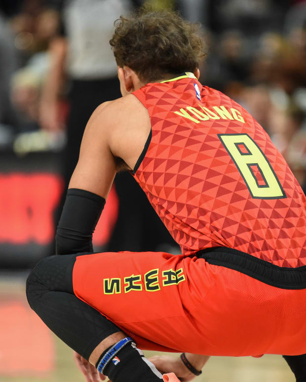 Atlanta Hawks guard Trae Young (11) wearing jersey number 8 to start the game to honor the memory of former NBA player Kobe Bryant holds the ball for 8 seconds at the start of the game against the Washington Wizards at State Farm Arena.