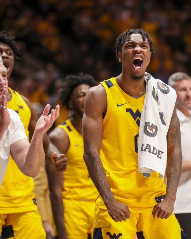 Nov 12, 2021; Morgantown, West Virginia, USA; West Virginia Mountaineers guard Kedrian Johnson (0) celebrates from the bench during the second half against the Pittsburgh Panthers at WVU Coliseum.