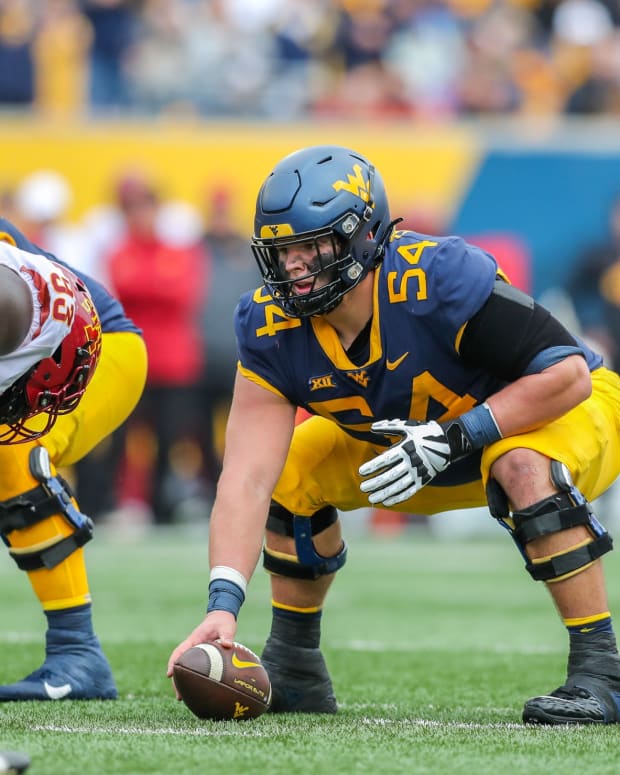 Oct 30, 2021; Morgantown, West Virginia, USA; West Virginia Mountaineers offensive lineman Zach Frazier (54) before a snap during the second quarter against the Iowa State Cyclones at Mountaineer Field at Milan Puskar Stadium.