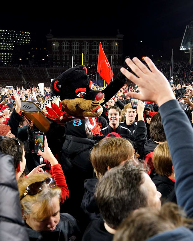 Cincinnati Bearcats fans celebrate on the field at the conclusion of the American Athletic Conference championship football game, Saturday, Dec. 4, 2021, at Nippert Stadium in Cincinnati. The Cincinnati Bearcats defeated the Houston Cougars, 35-20. Houston Cougars At Cincinnati Bearcats Aac Championship Dec 4
