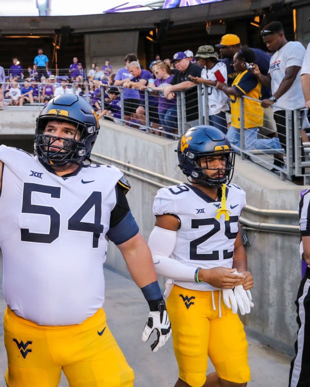 Oct 23, 2021; Fort Worth, Texas, USA; West Virginia Mountaineers offensive lineman Zach Frazier (54) gives a high five to fans prior to their game against the TCU Horned Frogs at Amon G. Carter Stadium.