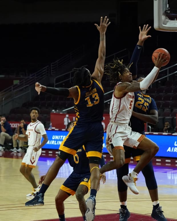 Dec 8, 2020; Los Angeles, California, USA; Southern California Trojans guard Isaiah White (5) shoots the ball as UC Irvine Anteaters forward Austin Johnson (13) and center Emmanuel Tshimanga (25) defend in the second half at Galen Center. USC defeated UCI 91-56. Mandatory Credit: Kirby Lee-USA TODAY Sports