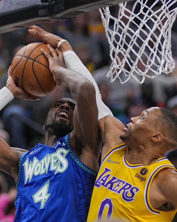 Dec 17, 2021; Minneapolis, Minnesota, USA; Los Angeles Lakers guard Russell Westbrook (0) fouls Minnesota Timberwolves guard Jaylen Nowell (4) in the third quarter at Target Center. Mandatory Credit: Brad Rempel-USA TODAY Sports
