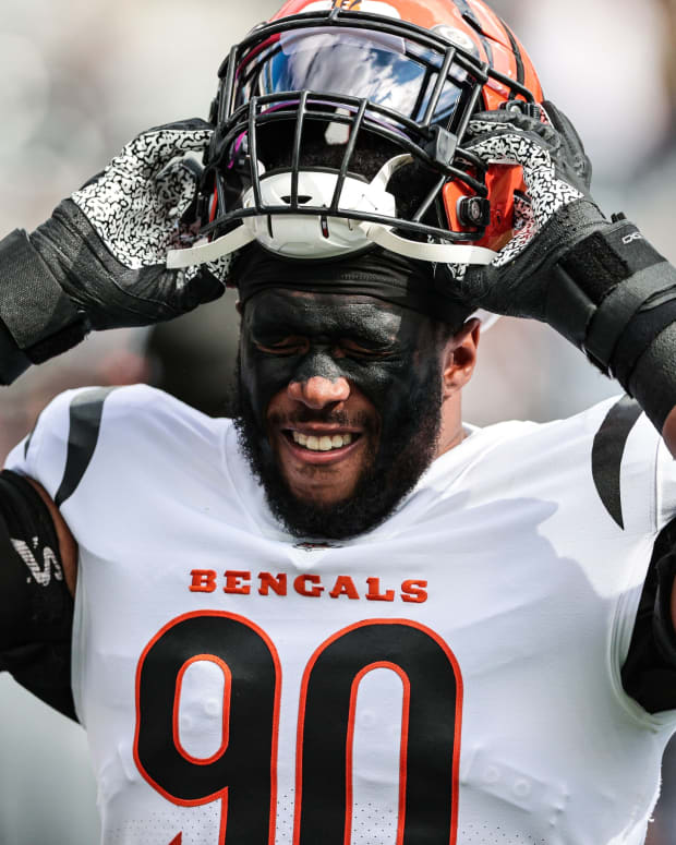 Oct 31, 2021; East Rutherford, New Jersey, USA; Cincinnati Bengals defensive end Khalid Kareem (90) puts on his helmet before the game against the New York Jets during the second half at MetLife Stadium. Mandatory Credit: Vincent Carchietta-USA TODAY Sports