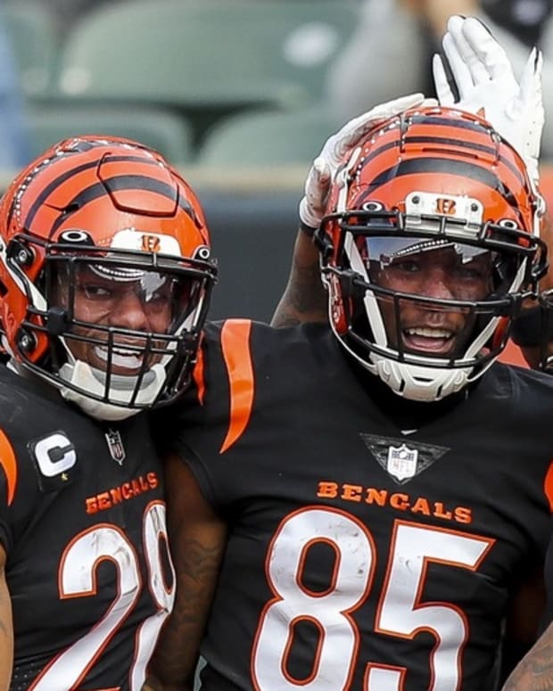Dec 26, 2021; Cincinnati, Ohio, USA; Cincinnati Bengals wide receiver Tee Higgins (85) reacts with running back Joe Mixon (28) and wide receiver Ja'Marr Chase (1) after scoring a touchdown against the Baltimore Ravens in the first half at Paul Brown Stadium. Mandatory Credit: Katie Stratman-USA TODAY Sports