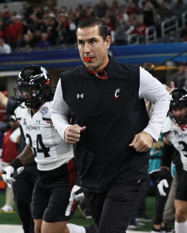 Dec 31, 2021; Arlington, Texas, USA; Cincinnati Bearcats head coach Luke Fickell takes the field with his team prior to the game against the the Alabama Crimson Tide during the 2021 Cotton Bowl college football CFP national semifinal game at AT&T Stadium. Mandatory Credit: Matthew Emmons-USA TODAY Sports