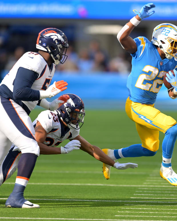 Jan 2, 2022; Inglewood, California, USA; Los Angeles Chargers running back Justin Jackson (22) gains a first down as he is chased by Denver Broncos cornerback Kyle Fuller (23) in the first quarter of the game at SoFi Stadium. Mandatory Credit: Jayne Kamin-Oncea-USA TODAY Sports
