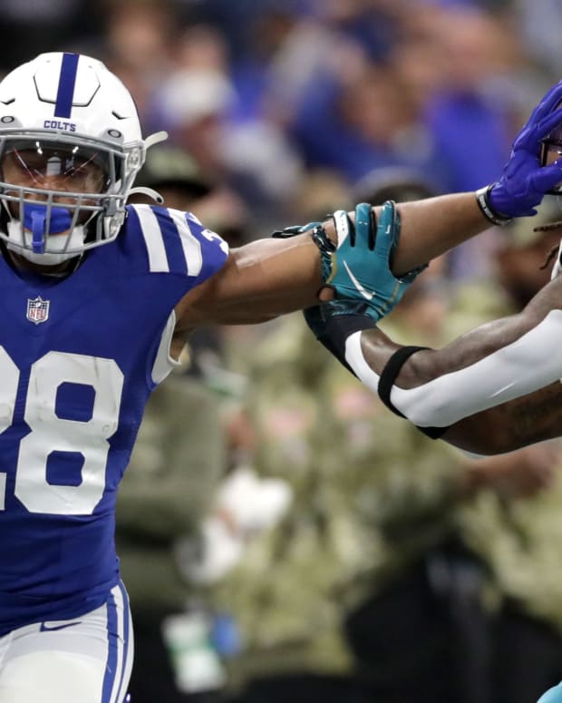 Indianapolis Colts running back Jonathan Taylor (28) still arms Jacksonville Jaguars free safety Rayshawn Jenkins (2) while rushing the ball Sunday, Nov. 14, 2021, during a game against the Jacksonville Jaguars at Lucas Oil Stadium in Indianapolis.