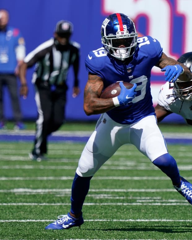 Sep 26, 2021; E. Rutherford, N.J., USA; New York Giants wide receiver Kenny Golladay (19) runs with the ball as Atlanta Falcons linebacker Steven Means (55) defends at MetLife Stadium.